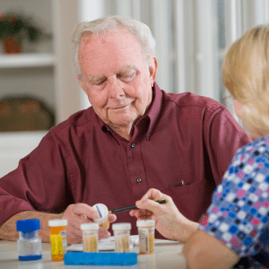 A compassionate nurse providing medication administration to an elderly patient, ensuring their well-being and care.