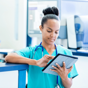 A focused nurse diligently engaged in charting and documentation tasks, ensuring accurate and comprehensive records in the medical field.