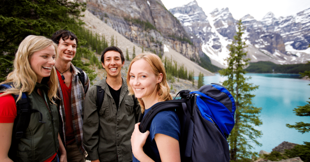 A group of friends enjoying a camping trip amidst majestic mountains. In this image, travel nurses find solace and fun as they explore the top camping states, creating lasting memories while immersed in nature's beauty. [Top Camping States for Travel Nurses]
