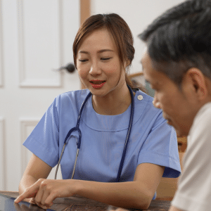 A nurse engaging in a discussion with a patient about treatment planning and implementation, showcasing the vital patient-centered care in a travel nurse's day.