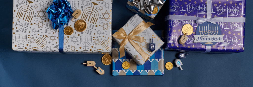 Table adorned with wrapped Hanukkah gifts, showcasing thoughtful Hanukkah gift ideas for nurses. The gifts are elegantly presented against a serene blue background, symbolizing the festive spirit of the holiday.