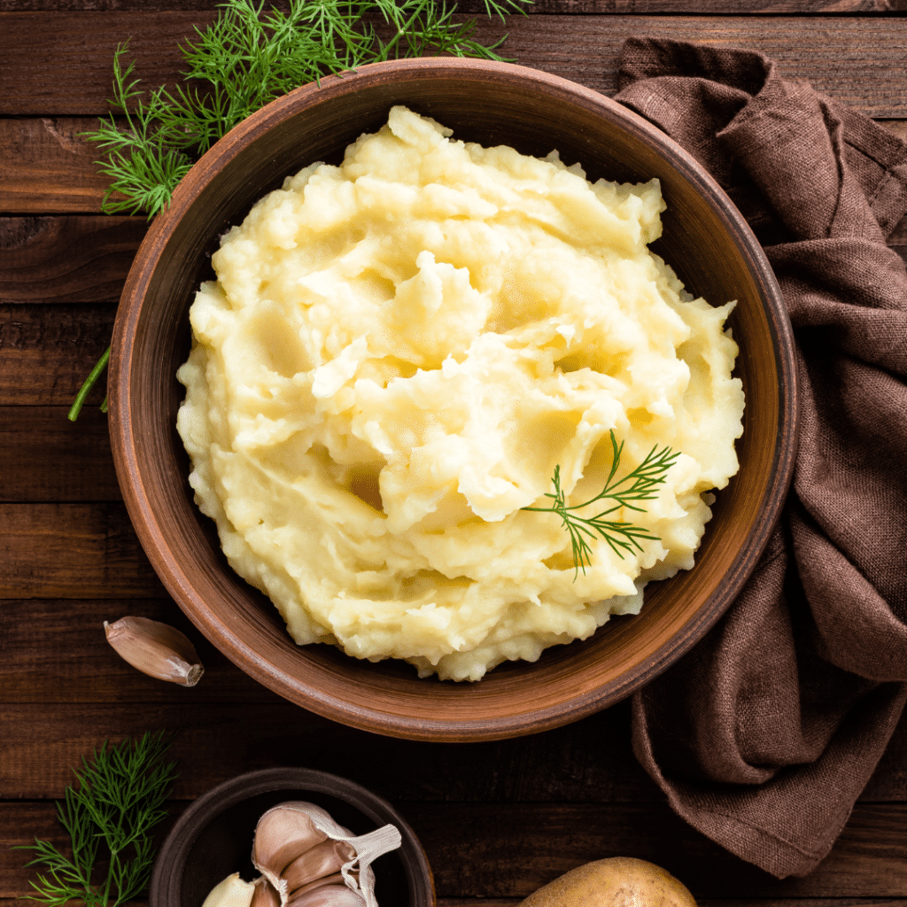 A bowl of creamy microwave mashed potatoes. This quick and easy meal option is ideal for travel nurses working on a temporary assignment during Thanksgiving, offering comfort and convenience in a busy schedule.