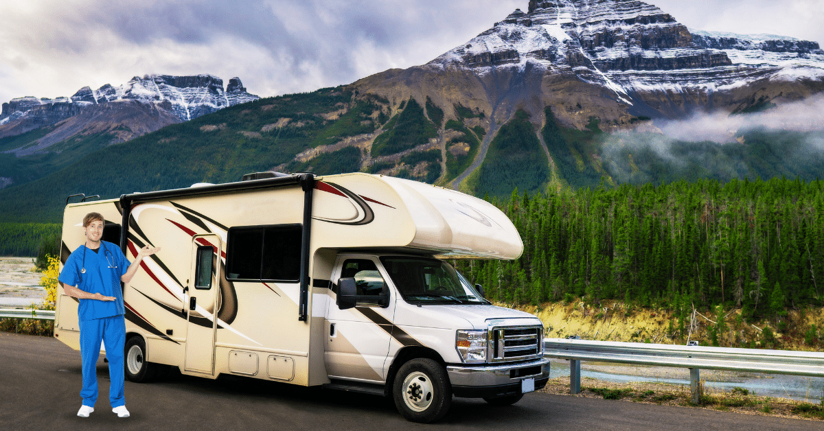 A cheerful male nurse in blue medical scrubs stands proudly outside his RV, which serves as his living quarters during his travel nurse assignment. The backdrop features a picturesque mountain setting, embodying the lifestyle of travel nurse RV living.