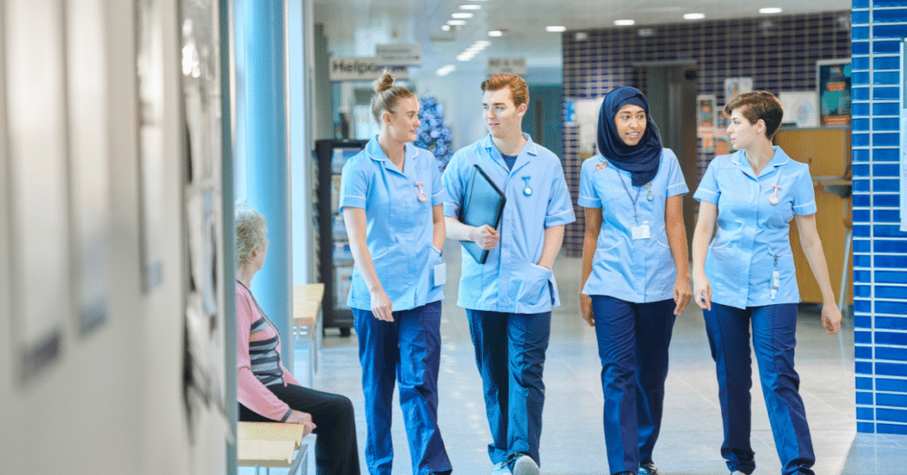 Nurses walking in a hospital during their daytime 5x8 shift. This image highlights the difference between traditional 4x12 nursing shifts and longer 4x12 nursing shifts, capturing the unique dynamics and environment of the latter.