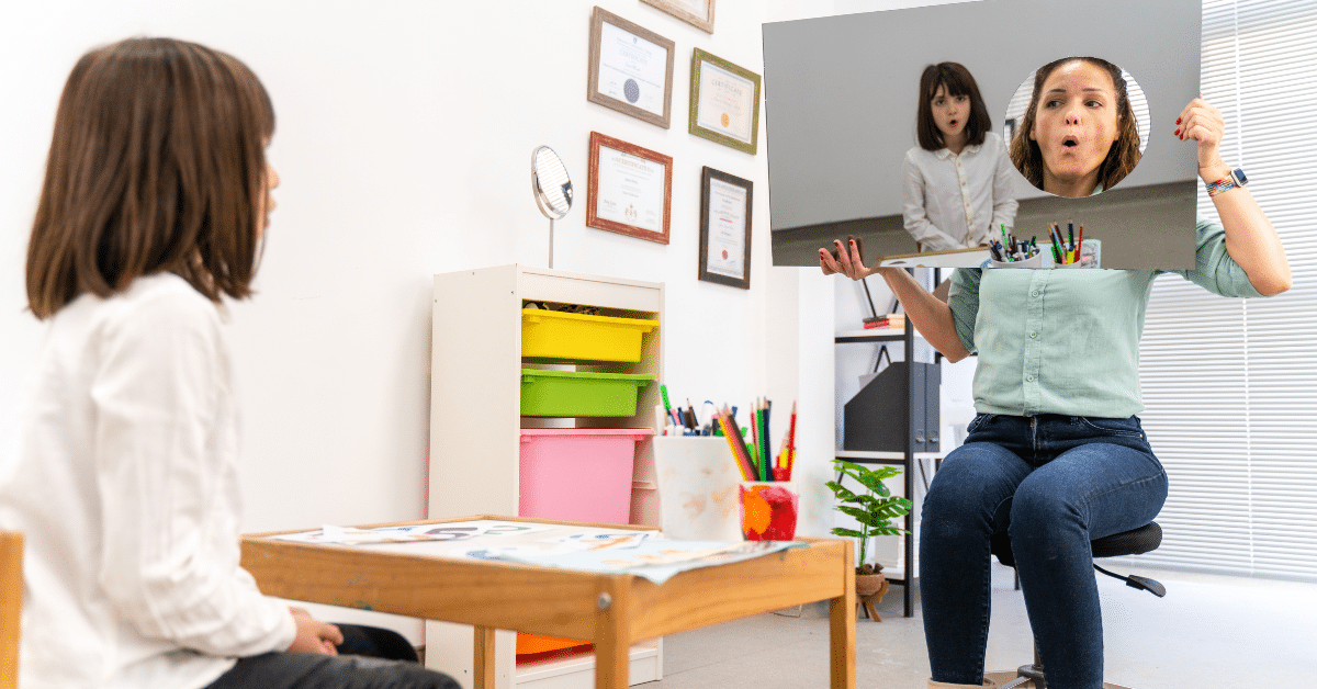 The image portrays a young girl in a speech therapy office, engaged in pronunciation exercises with a speech therapist. The girl is seen in front of a mirror, reflecting her image as she practices her speech. The mirror features a unique design, with a circular cut-out where the speech therapist is visible. The therapist is demonstrating how to pronounce a particular word, guiding the girl in her exercise. This scene captures the challenges faced by speech language pathologists in their efforts to assist individuals with speech difficulties.