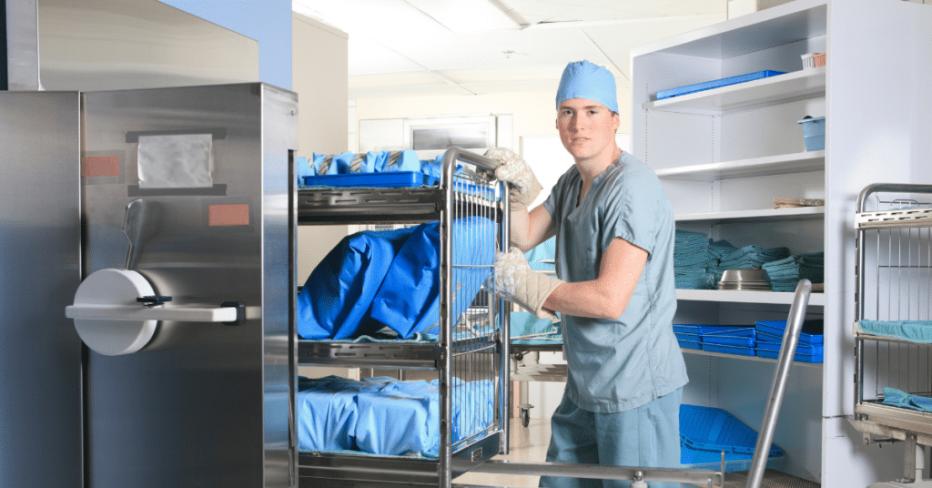 A sterile processing technician in a hospital setting is depicted actively engaged in their daily tasks. The technician, dressed in scrubs and protective gear, is shown meticulously cleaning and sterilizing medical instruments. The background features an array of medical supplies. The atmosphere conveys a sense of professionalism and cleanliness, essential in a hospital environment. The technician's focused expression and careful handling of the medical supplies reflects his dedication to ensuring patient safety and maintaining high standards of hygiene.